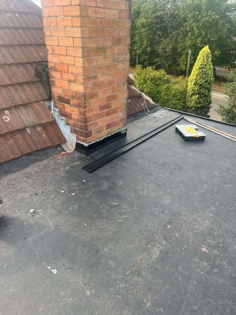 This is a photo of a flat roof which has just been repaired, there is also a chimney stack and some leadwork has also been dressed. Works carried out by MCM Roofing Repairs Salisbury